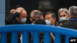 FILE - Members of the World Health Organization team investigating the origins of the COVID-19 coronavirus visit the closed Huanan Seafood Market in Wuhan, China, Jan. 31, 2021. 
