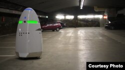 This photo from California manufacturer Knightscope shows the company's K5 security robot keeping tabs on a parking area.