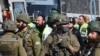 Israeli rescuers and security forces work at the site of an attack near the village of al-Funduq, in the occupied West Bank, on January 6, 2025.