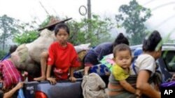 In this photo taken Tuesday, June 9, 2009 released by Free Burma Rangers, Karen villagers board a pickup truck as they flee the fighting between Myanmar soldiers and Karen guerrillas into Thailand's Tha Song Yag district of Tak province. More than 4,000 e