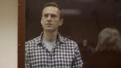 FILE - Kremlin critic Alexei Navalny stands inside a defendant dock during a court hearing in Moscow, Russia, Feb. 20, 2021, in this still image taken from video. (Press Service of Babushkinsky District Court of Moscow/Handout)