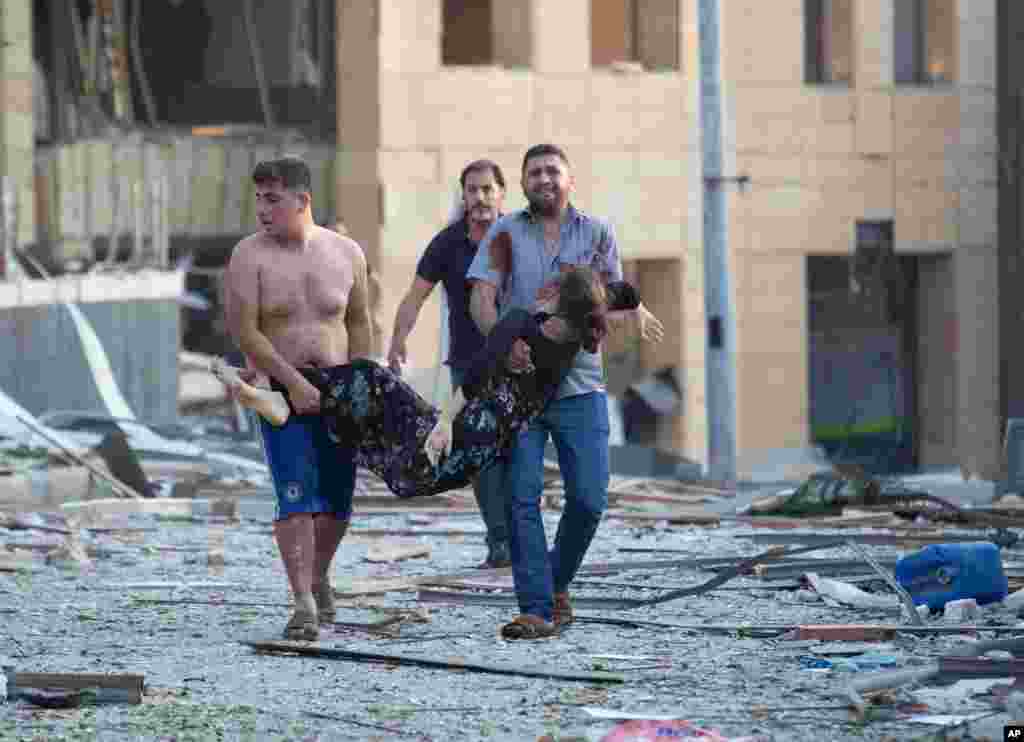 A wounded person is evacuated after a massive explosion in Beirut, Lebanon, rippling through several parts of the city, causing widespread damage and very high number of injuries.