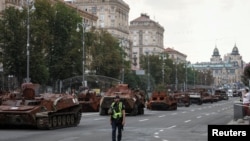 FILE - People attend an exhibition displaying destroyed Russian military vehicles located on the main street Khreshchatyk in central Kyiv, Ukraine Aug. 21, 2023. 