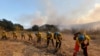 A hotshot crew works on a fireline while the Bond Fire burns in Silverado, Calif., on Dec. 3, 2020. 