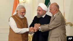 A photo released by the official website of the office of the Iranian Presidency, shows Afghan President Ashraf Ghani (R), Iranian President Hassan Rouhani (C), and Indian Prime Minister Narendra Modi, holding hands in a show of solidarity after their trilateral meeting and signing agreements in Tehran, May 23, 2016.