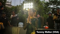 A woman reacts at the scene of a fiery bus crash that killed 22 students and three teachers, in suburban Bangkok, Oct. 1, 2024.