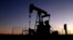 FILE - A pumpjack operates at dawn in a pasture, Sept. 30, 2024, near Hays, Kan. 