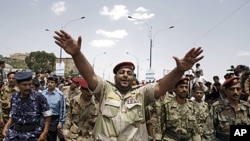 Yemeni army soldiers, who defected, join a demonstration demanding the resignation of President Ali Abdullah Saleh in Sana'a, September 16, 2011.