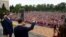 Chinese President Xi Jinping, center, accompanied by Serbian President Aleksandar Vucic, greets the people gathered outside the Palace of Serbia during a a welcome ceremony in Belgrade on May 8, 2024. (Serbia's Presidential Press Service via AFP)