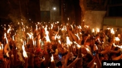 Orthodox Christian worshippers attend the Holy Fire ceremony amid eased COVID-19 restrictions, at the Church of the Holy Sepulchre in Jerusalem's Old City, May 1, 2021. 