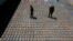 FILE - Police officers walk among packages of seized cocaine at the pacific port of Buenaventura, Colombia, Aug. 10, 2017. 