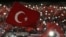 FILE - Supporters of Turkey's President Tayyip Erdogan wave Turkey's national flags as they wait for his speech during a rally against terrorism in Strasbourg, France, Oct. 4, 2015.