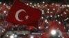 Supporters of Turkey's President Tayyip Erdogan wave Turkey's national flags as they wait for his speech during a rally against terrorism in Strasbourg, France, Oct. 4, 2015.