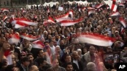 Anti-government protestors hold Egyptian flags during a demonstration at Tahrir Square in Cairo, Egypt, Wednesday, Feb. 9, 2011.