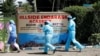 Officers from the office of government pathologist walk outside the Hillside Endarasha Academy, after a fatal fire killed and injured several pupils, in Kieni, Nyeri County, Kenya, Sept. 7, 2024. 