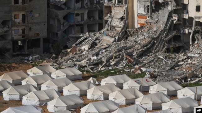 A tent camp for displaced Palestinians is set up next to destroyed buildings following the Israeli air and ground offensive in Jabaliya, Gaza Strip, Feb. 6, 2025.