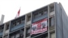 A banner that shows images of Pope Francis and Luis Figari, the founder of a Catholic lay movement in Peru, that reads, "Francisco, here we do have proof," hangs in Lima on Jan. 21, 2018. Francis on Sept. 25, 2024, expelled 10 people in connection with abuses within the group.