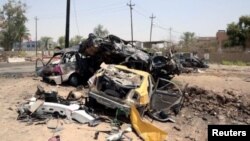 Destroyed vehicles are seen at the site of a suicide car bomber in Khalis, north of Baghdad, Iraq, July 25, 2016.