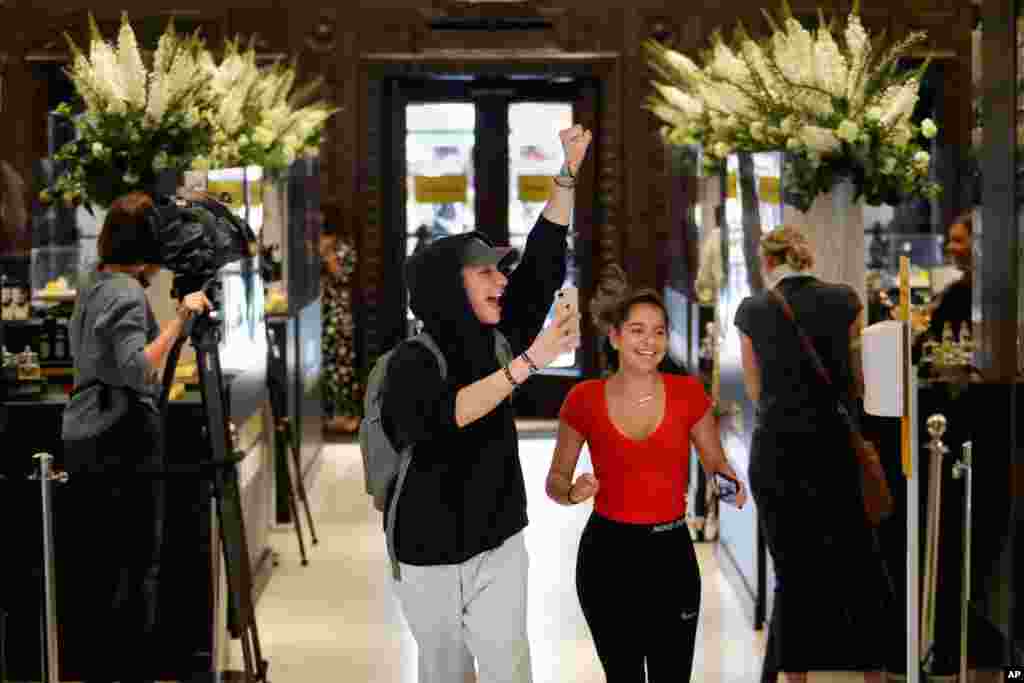 Customers cheer as they are allowed in the Selfridges department store in London. Shops selling fashion, toys and other non-essential goods re-open amid the COVID-19 outbreak.