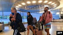 (FILES) In this file photo taken on March 13, 2020 Passengers arrive at Los Angeles Airport international terminal hours before the start of the European travel ban, March 13, 2020, in Los Angeles, California. - The US on August 6, 2020, lifted a…