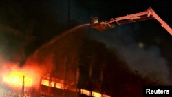 Para petugas pemadam kebakaran memadamkan api di kantor Kejaksaan Agung di Jakarta, Sabtu, 22 Agustus 2020. (Foto: Reuters)