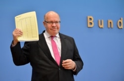 FILE - German Economy Minister Peter Altmaier arrives for a news conference to present the government's economic spring projection, amid the novel coronavirus COVID-19 pandemic in Berlin, Germany, April 29, 2020.