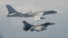 FILE - A Taiwanese F-16 fighter jet flies next to a Chinese H-6 bomber, top, in Taiwan's airspace, in this handout photo taken and released Feb. 10, 2020, by Taiwan's Defense Ministry.