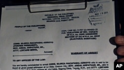 A copy of the arrest warrant served on former president and Pampanga Representative Gloria Macapagal Arroyo is shown to media at St. Luke's Medical Center in Taguig City, Manila, November 18, 2011