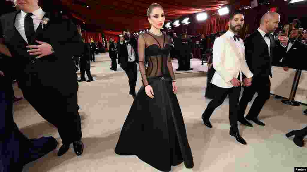 Lady Gaga and BloodPop pose on the champagne-colored red carpet during the Oscars arrivals at the 95th Academy Awards in Los Angeles, March 12, 2023. (Photo by Mario Anzuoni/Reuters)