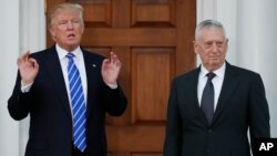 FILE - President-elect Donald Trump stands with retired Marine Corps Gen. James Mattis at Trump National Golf Club Bedminster clubhouse in Bedminster, New Jersey, Nov. 19, 2016.