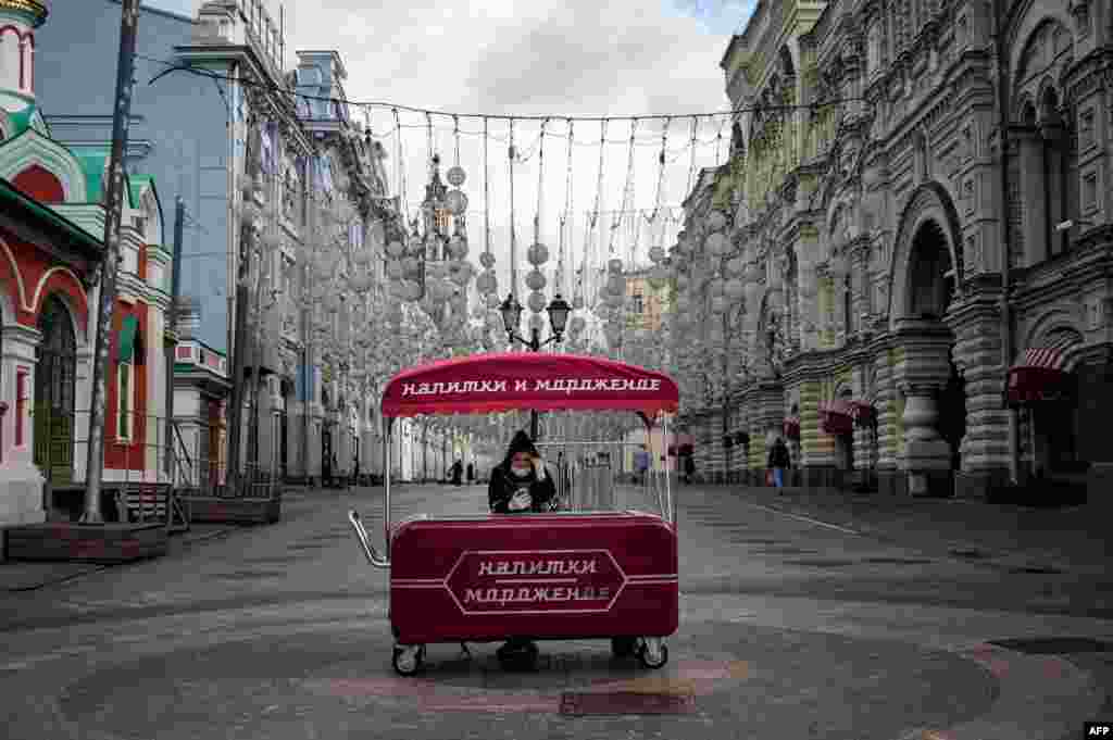 A woman wearing a protective face mask sells ice cream in downtown Moscow.