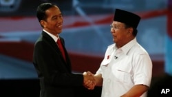 Joko Widodo (kiri) berjabat tangan dengan Prabowo Subianto usai Debat Capres 2014 pada tanggal 15 Juni 2014 (foto: dok). 