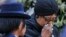 FILE - Winnie Madikizela-Mandela, Nelson Mandela's former wife, walks away after paying her respect to former South African President Nelson Mandela during the lying in state at the Union Buildings in Pretoria, South Africa, Dec. 11, 2013. 