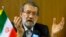 Ali Larijani, Speaker of the Iranian Parliament, gestures during a news conference after the 129th Assembly of the Inter-Parliamentary Union in Geneva, Oct. 9, 2013.