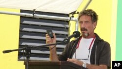 FILE -John McAfee speaks at a ceremony for the official presentation of equipment at the San Pedro Police Station in Ambergris Caye, Belize. 