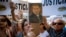 A woman holds a portrait of the late prosecutor Alberto Nisman outside the AMIA Jewish community center in Buenos Aires, Argentina, Jan. 21, 2015.