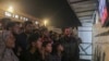 Palestinians watch a TV broadcast as they await the announcement of a ceasefire deal between Hamas and Israel, in Khan Younis, central Gaza Strip, Jan. 15, 2025.