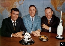 FILE - In this April 10, 1970, photo made available by NASA, Apollo 13 astronauts, from left, Fred Haise, Jack Swigert and Jim Lovell pose for a photo on the day before launch.