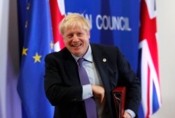 FILE - British Prime Minister Boris Johnson leaves the podium after addressing a news conference at an EU summit in Brussels, Oct. 17, 2019.