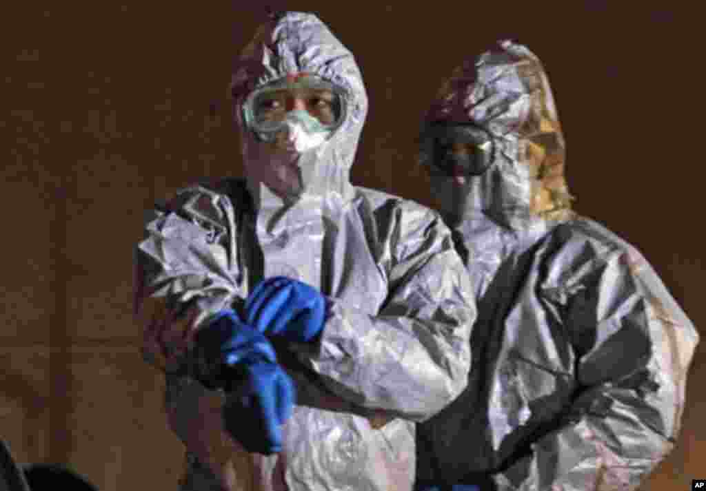 Officials in protective gear near the Fukushima Daiichi nuclear plant, in Koriyama, March 13, 2011