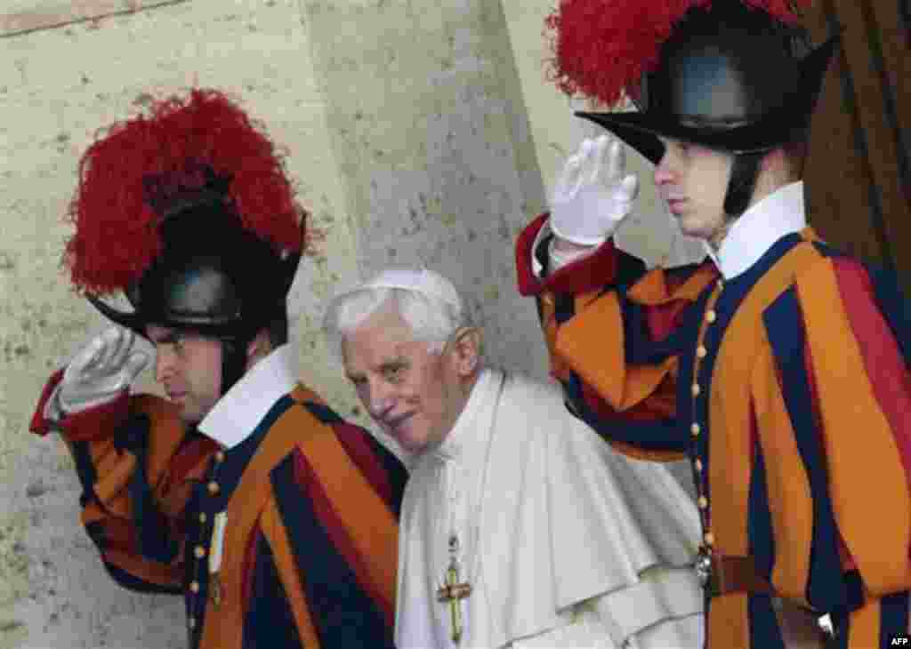 Pope Benedict XVI is saluted by Swiss guards as he leaves the Synod hall after a meeting with Cardinals and Bishops at the Vatican, Friday, Feb. 17, 2012. The Pontiff is scheduled to name 22 new Cardinals in a Consistory, Saturday Feb. 18, at the Vatican.