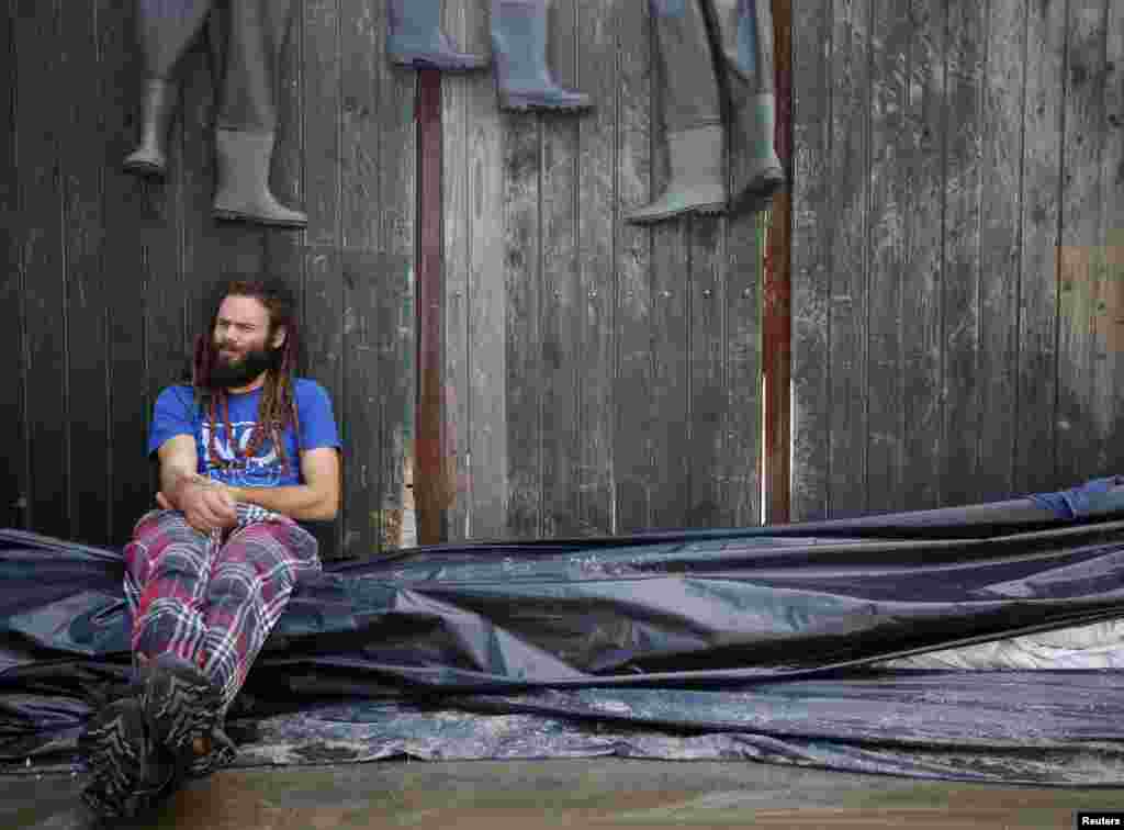 A volunteer rests in Nagymaros, west of Budapest, Hungary, June 8, 2013. 