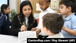 Teaching assistant Dilia Samadova teaches a math lesson in Mrs. Zenobi's kindergarten class at Our Lady of Peace School, Dec.11, 2019. (CantonRep.com / Ray Stewart)