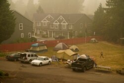 Evacuees from the Riverside Fire stay in tents at the Milwaukie-Portland Elks Lodge, Sunday, Sept. 13, 2020, in Oak Grove, Ore.
