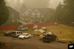 Evacuees from the Riverside Fire stay in tents at the Milwaukie-Portland Elks Lodge, Sunday, Sept. 13, 2020, in Oak Grove, Ore.