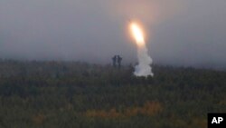 An air defense missile system flies during a military exercises on training ground "Telemba," about 80 kilometers (50 miles ) north of the city of Chita during the military exercises Vostok 2018 in Eastern Siberia, Russia, Sept. 12, 2018. 