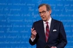 FILE - Moderator Chris Wallace of Fox News speaks on stage before the start of the first presidential debate, Sept. 29, 2020, at Case Western Reserve University and Cleveland Clinic, in Cleveland, Ohio.