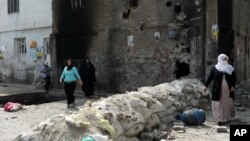 People emerge from their homes following the lifting of a curfew in the mainly Kurdish town of Cizre, Turkey, Sept. 12, 2015.