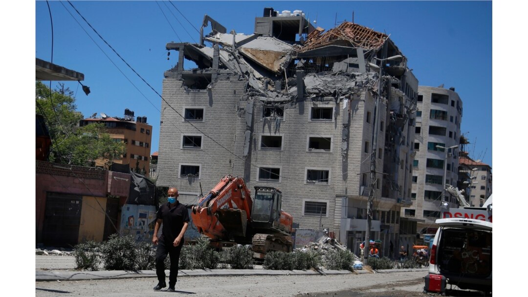 A Palestinian passes a building hit by an Israeli attack in Gaza City, May 18, 2021.