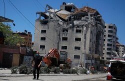 A Palestinian passes a building hit by an Israeli attack in Gaza City, May 18, 2021.